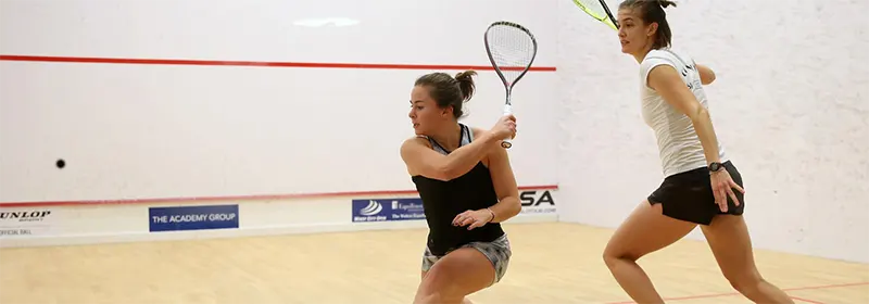 Two ladies playing squash