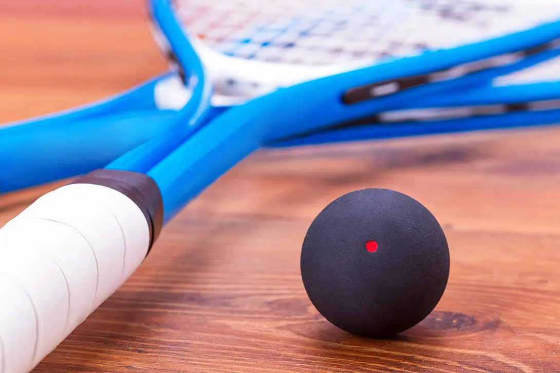 Two cheap squash rackets and a ball