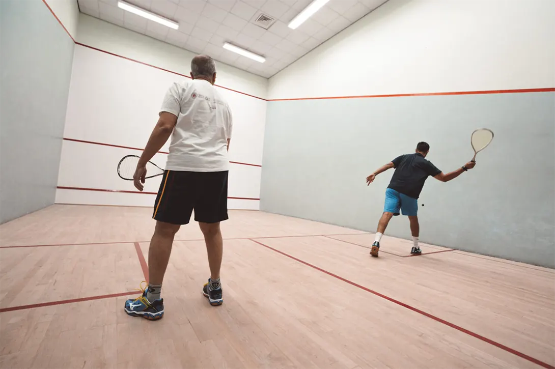 Two gentlemen playing squash